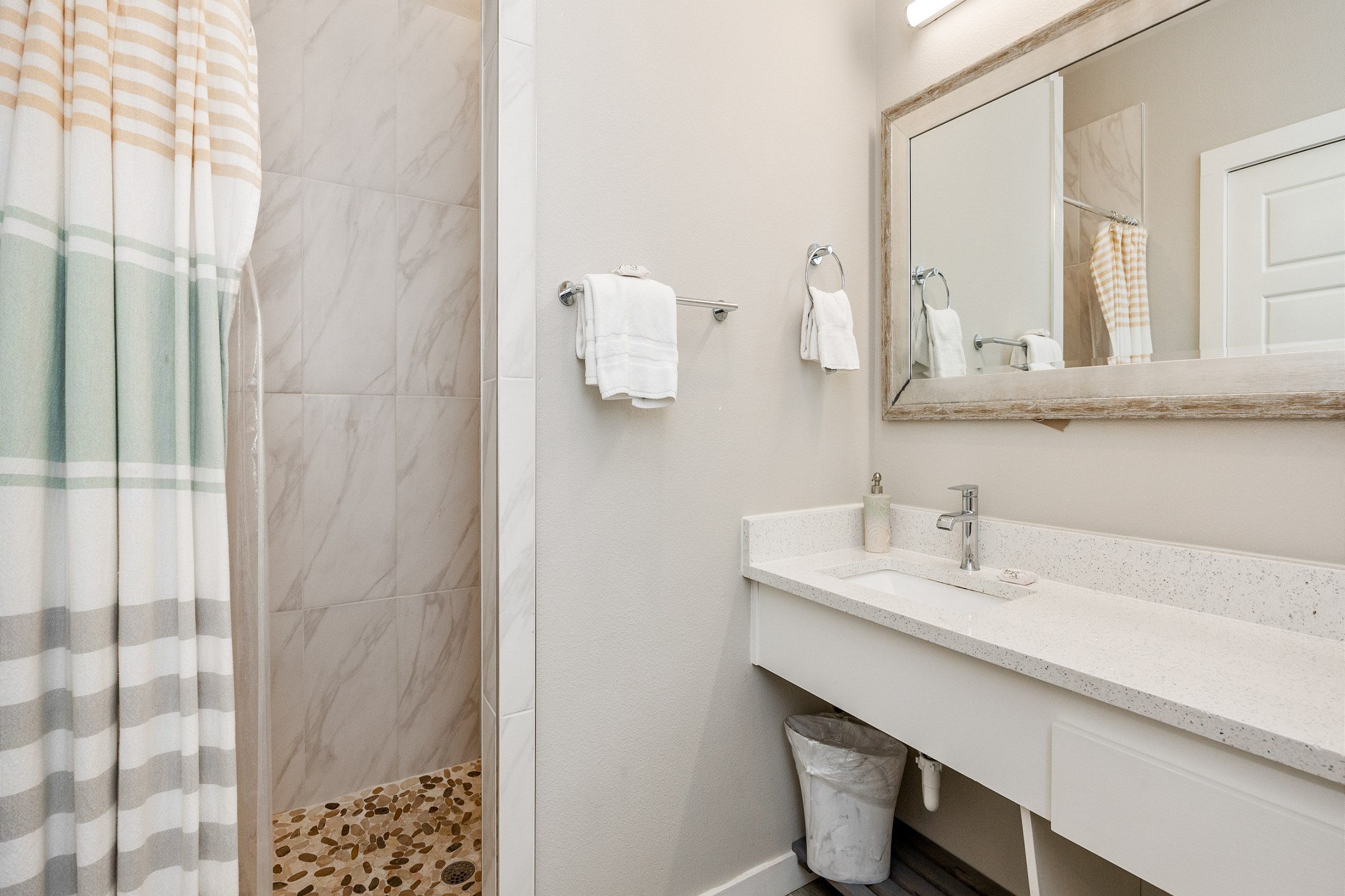 Full bathroom with single sink, toilet, and walk-in shower