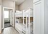 Twin size bunk beds and washer / dryer in hallway