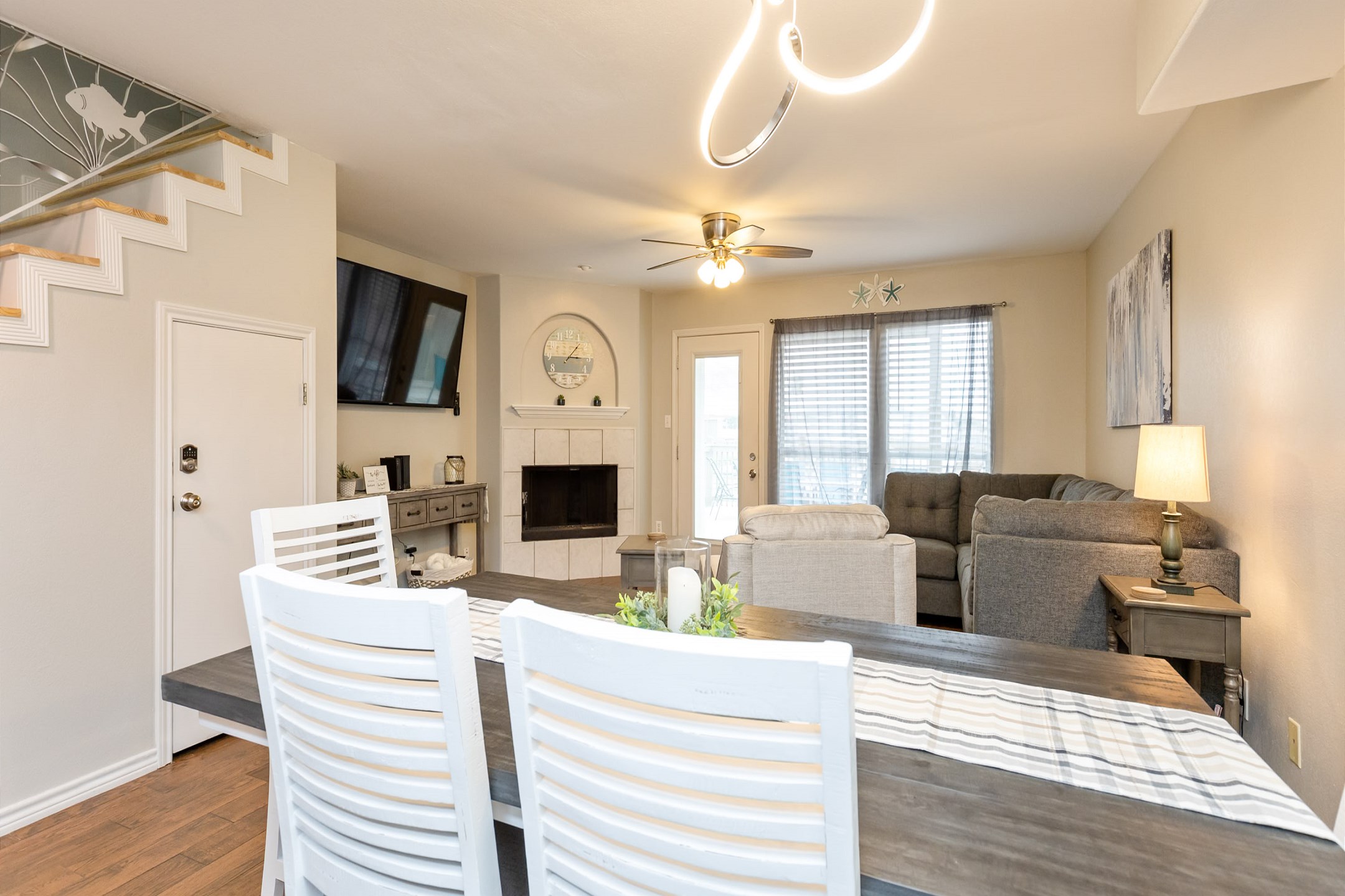 Dining and living space with vibrant, fun lighting that creates a lively atmosphere