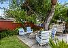 Backyard space with cozy seating to relax around the pool and canal 