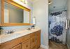 Guest bathroom with double sinks, tub and shower