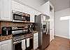 Fully equipped kitchen with stainless steel appliances and plenty of storage