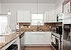 Fully equipped kitchen with stainless steel appliances and plenty of storage