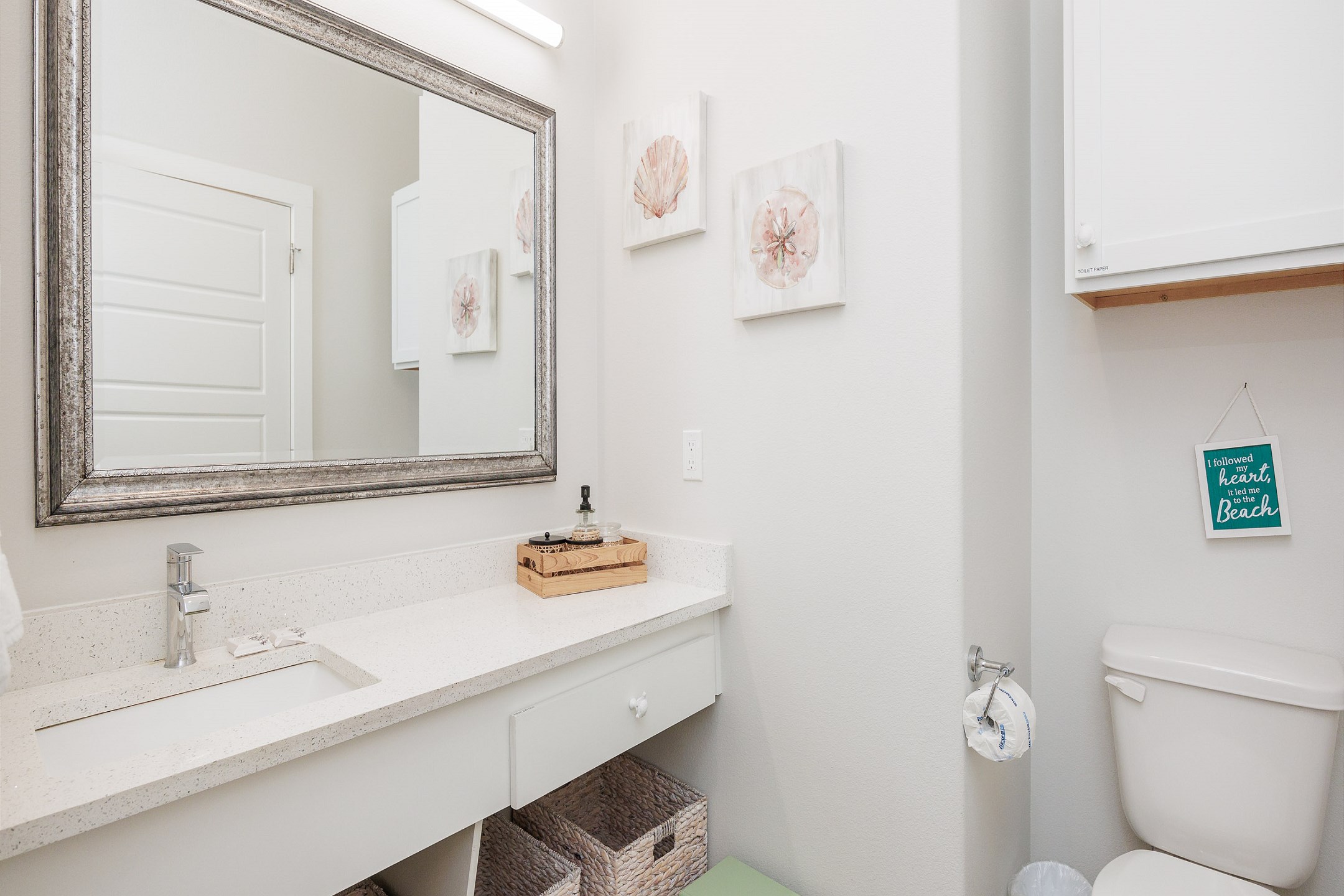 Stylish bathroom boasting a sleek toilet and contemporary sink with ample counter space 