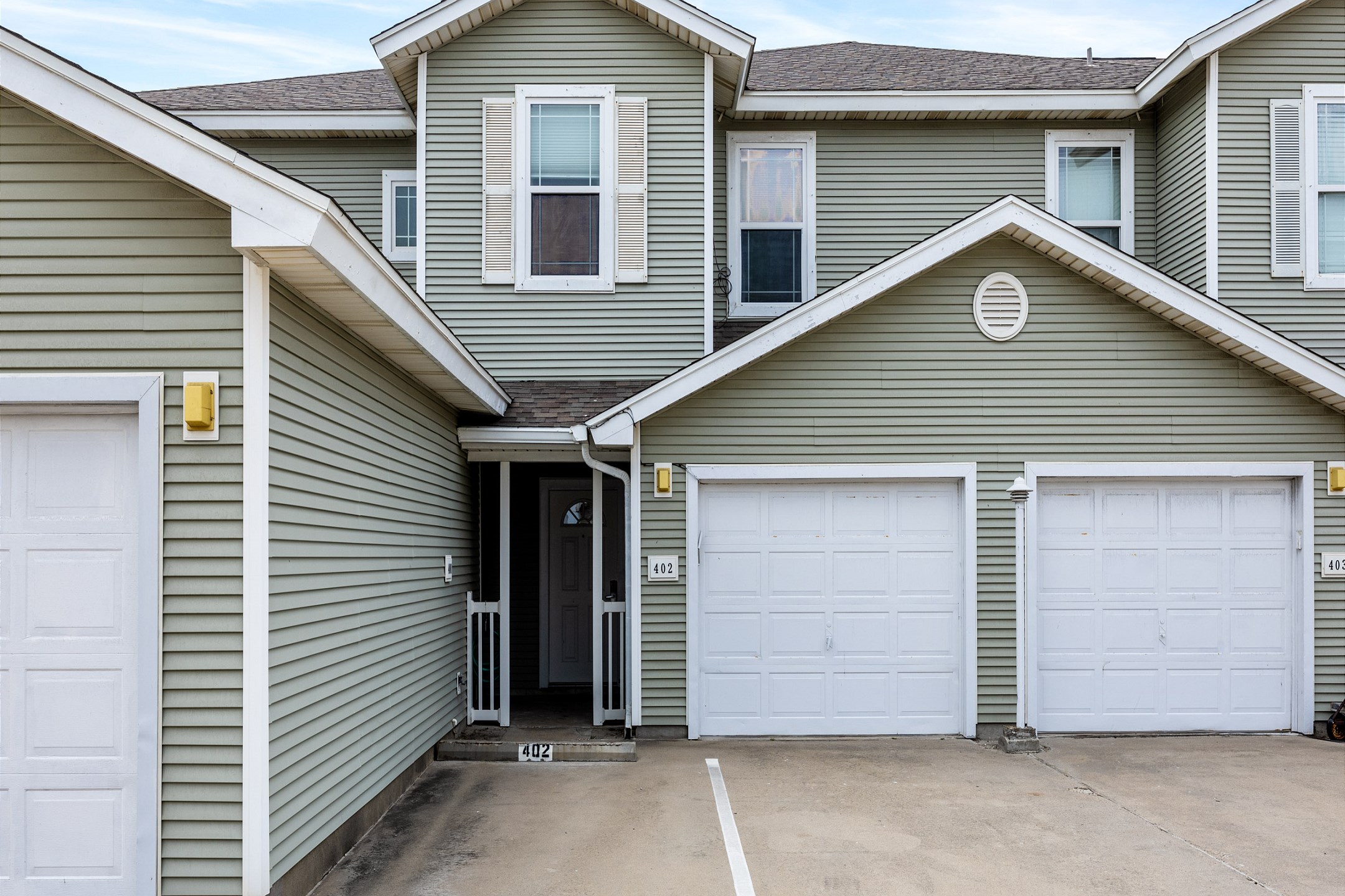 Reserved parking for one vehicle in front of entrance and garage access with parking for one vehicle