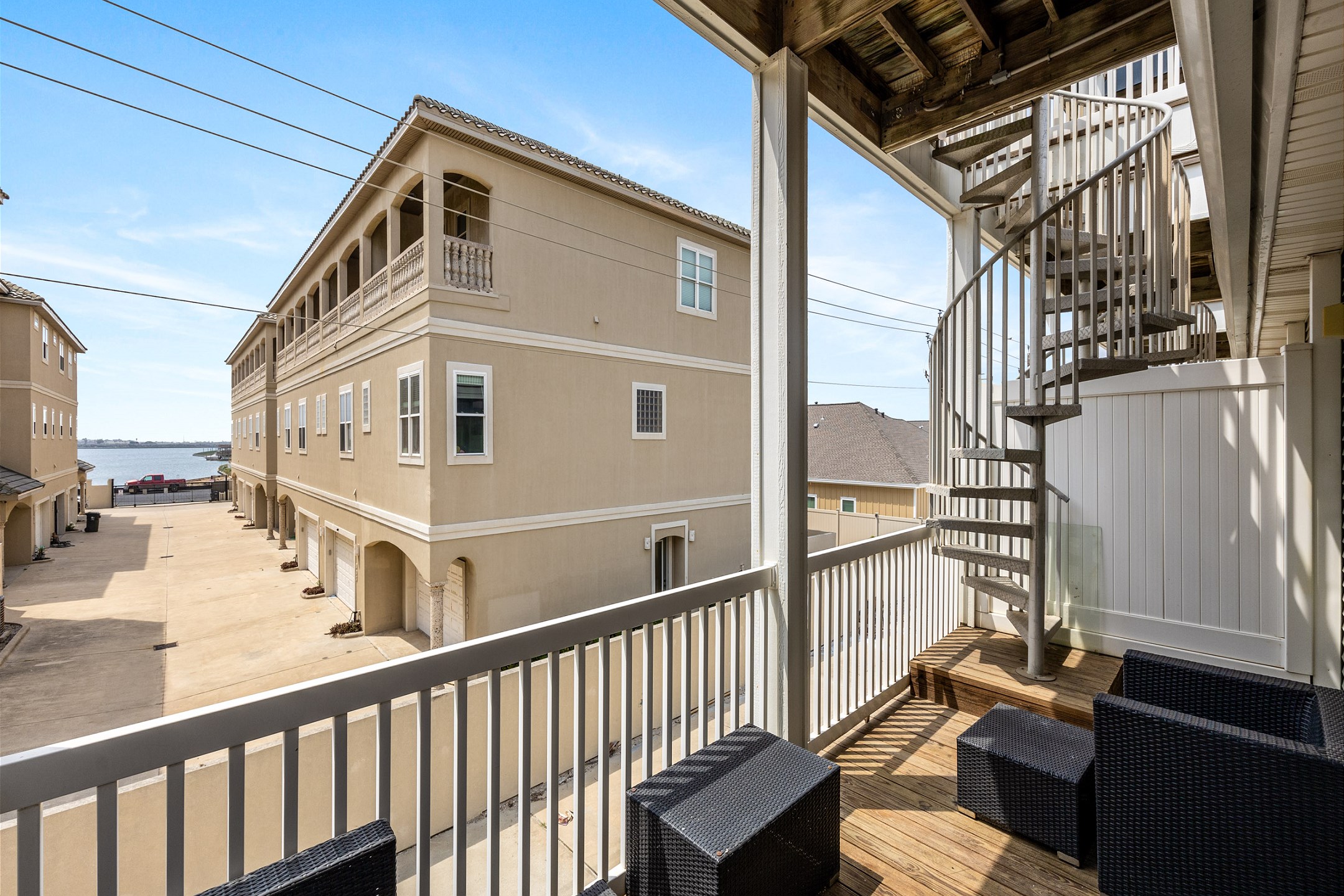 Stairway off master balcony leading to top level deck with views of Whitecap Beach 