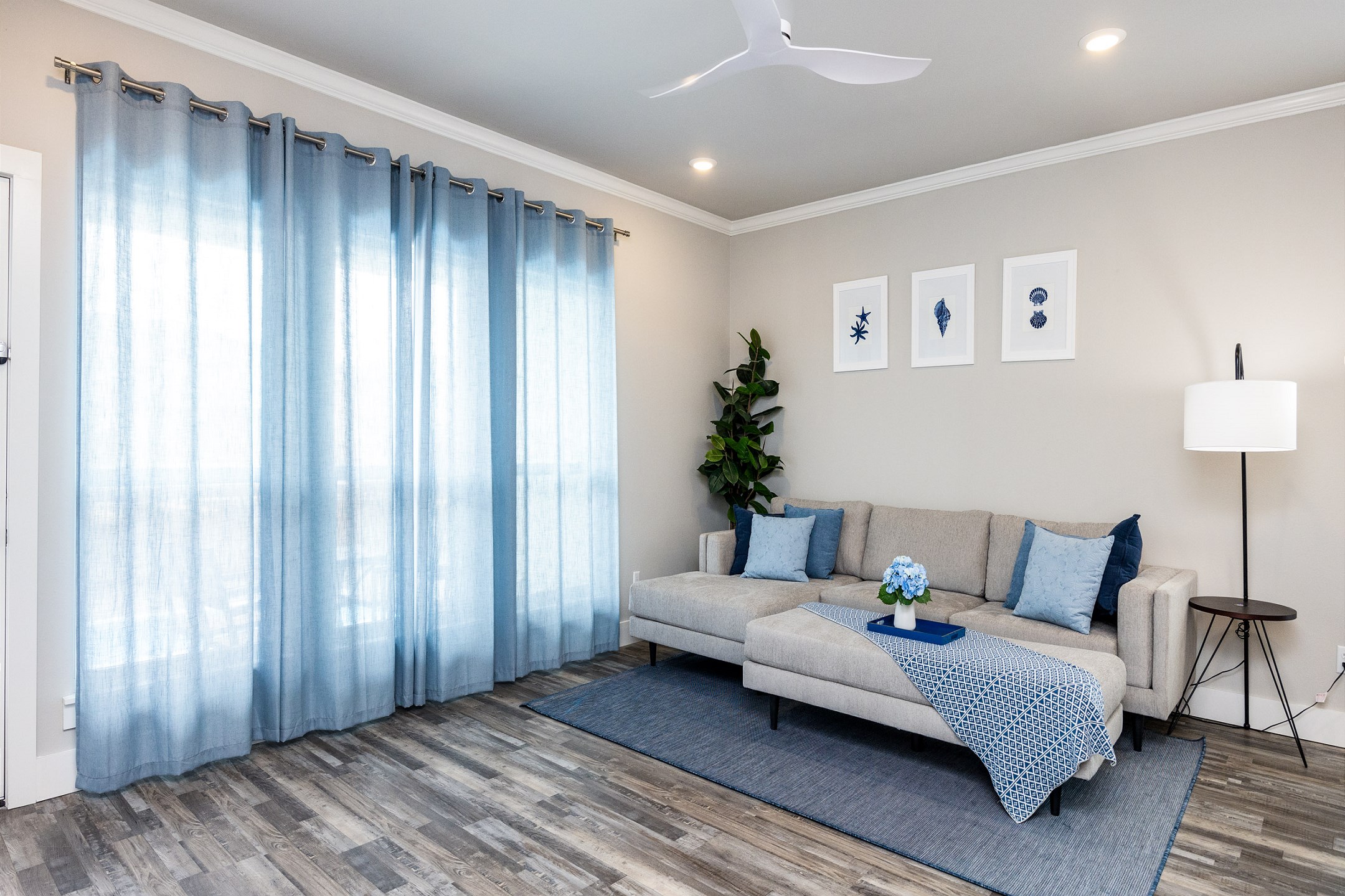 Comfortable living area with coastal features, queen size sleeper sofa and flat screen TV 