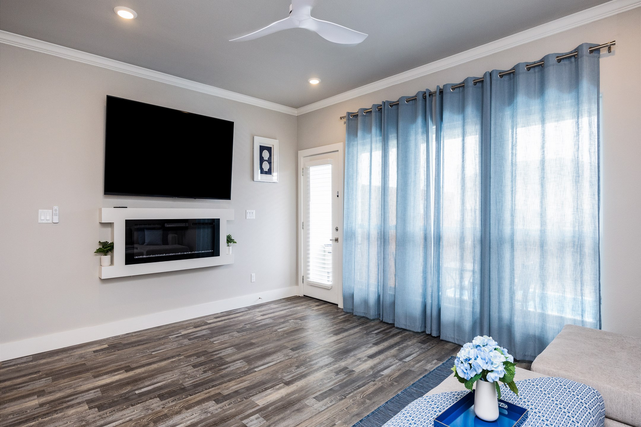 Living area with flat screen TV and patio access to a private plunge pool 
