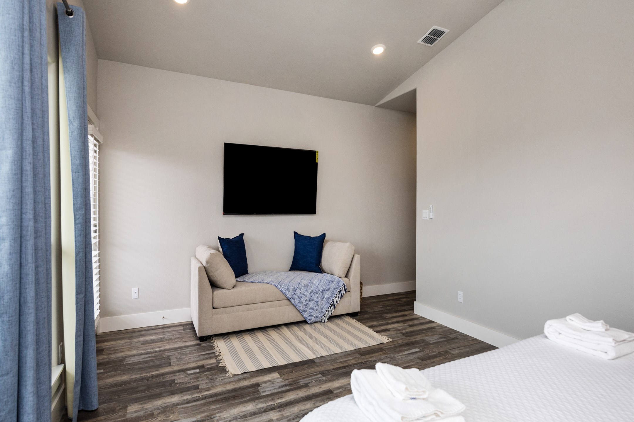 Master bedroom with king size bed, twin sleeper chaise, private bathroom, and balcony access - along with flat screen TV