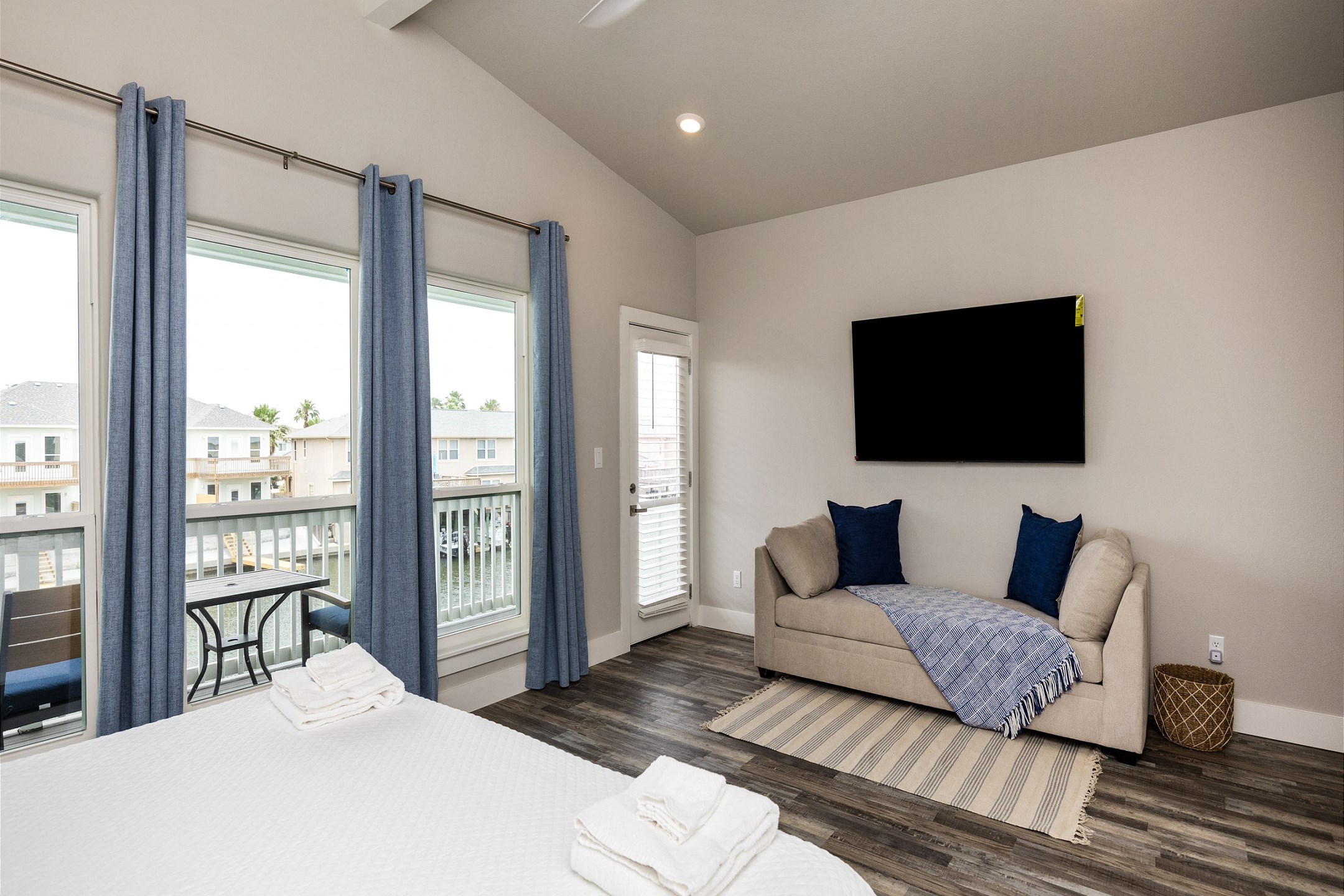 Master bedroom with king size bed, twin sleeper chaise, private bathroom, and balcony access - along with flat screen TV