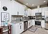 Well equipped kitchen with stainless steel appliances and beautiful counter tops 