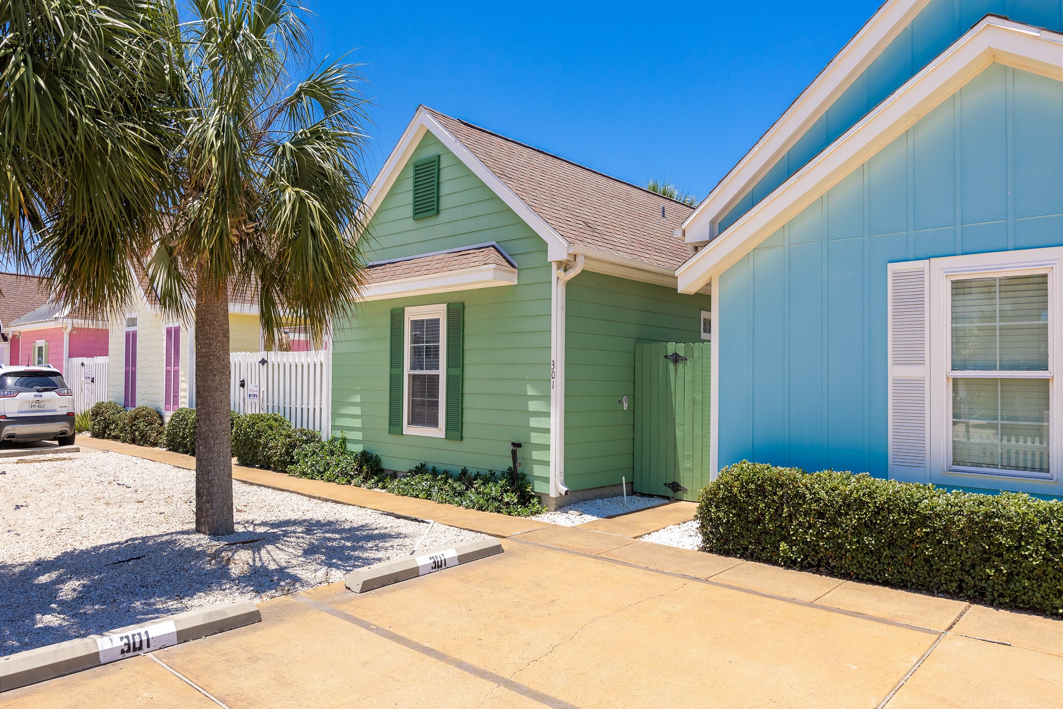 Front view of the property with reserved parking for two vehicles right outside the gate