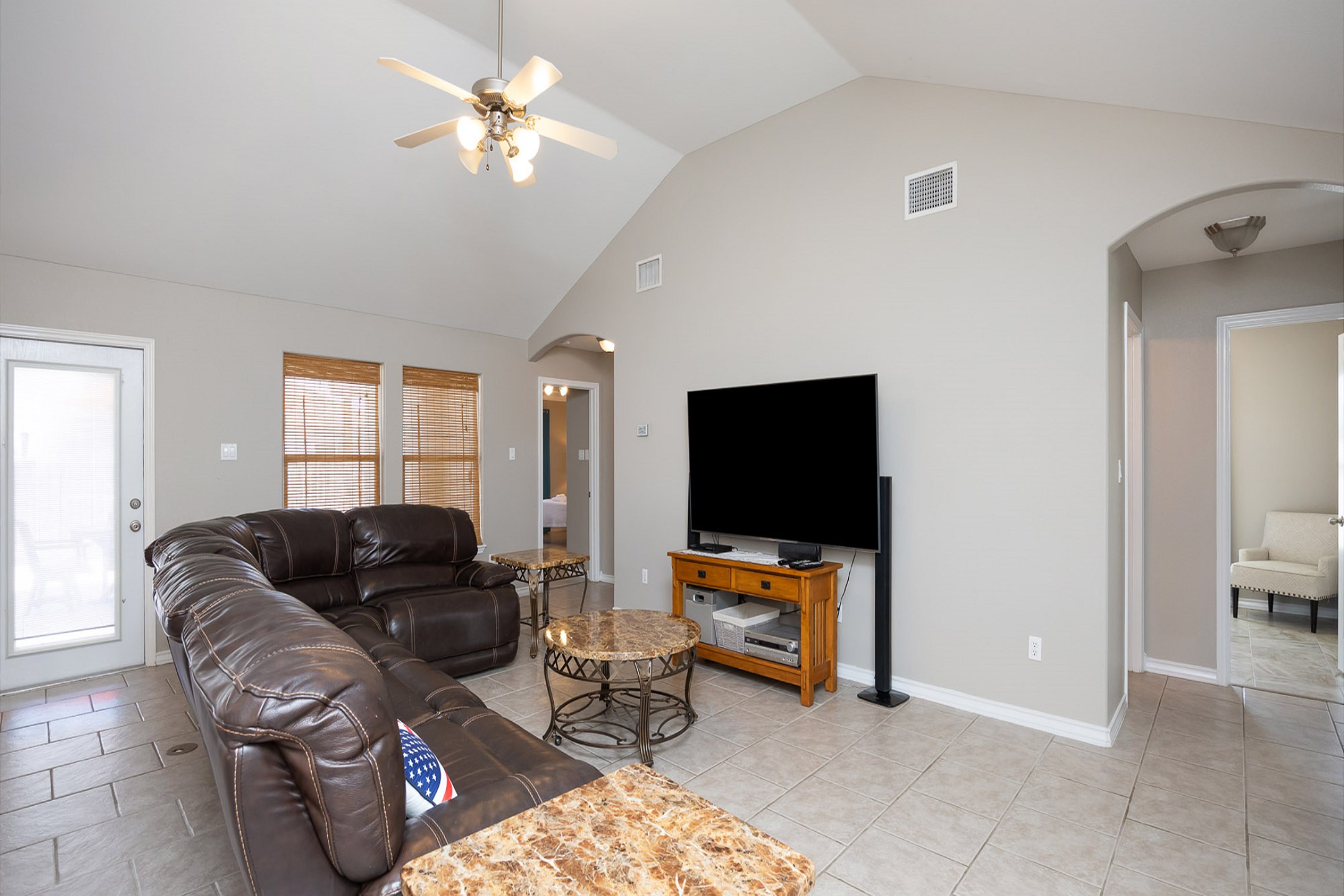 Open concept living area with back patio access 