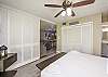 Master bedroom with king size bed and private bathroom with shutters that open up