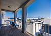 Private balcony off the master bedroom with cozy seating and ocean views 