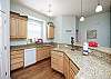 Well equipped kitchen with beautiful counter tops and plenty of space for cooking 