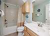 Guest bathroom located off the fourth bedroom on the first floor with tub and shower