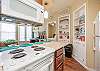 Open concept kitchen area with barstools and coffee maker 