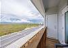 Private balcony off the second bedroom with chairs and Island views 