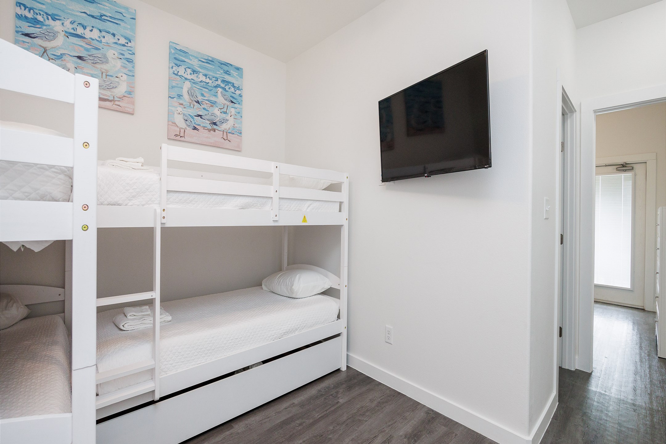 Loft area on the second floor with two sets of twin size bunk beds, one twin trundle, and flat screen TV 