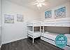 Loft area on the second floor with two sets of twin size bunk beds, one twin trundle and flat screen TV 