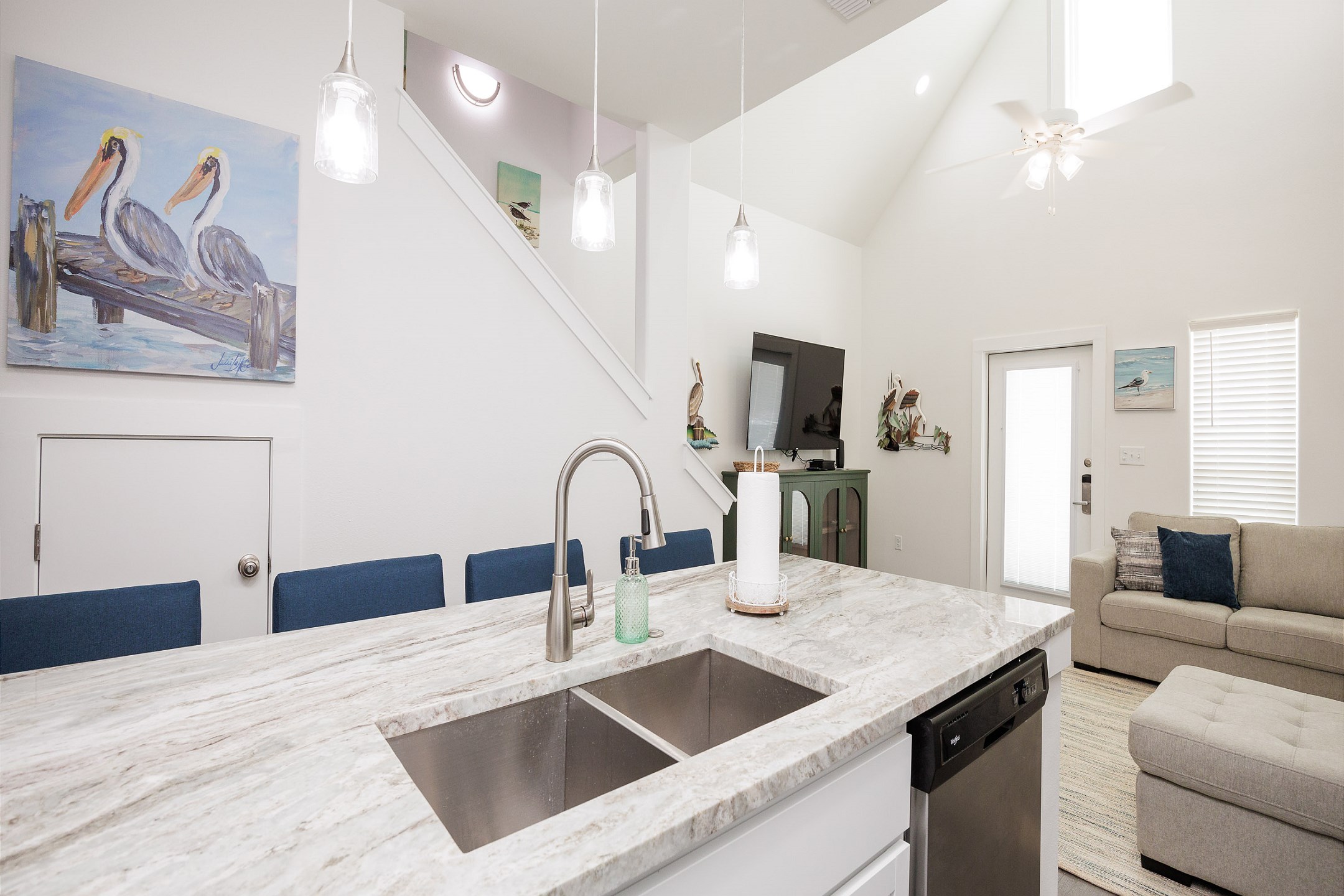 Open concept kitchen space with breakfast bar, beautiful counter tops and new lighting 