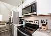 Fully equipped kitchen with stainless steel appliances, beautiful counter tops and coffee maker 