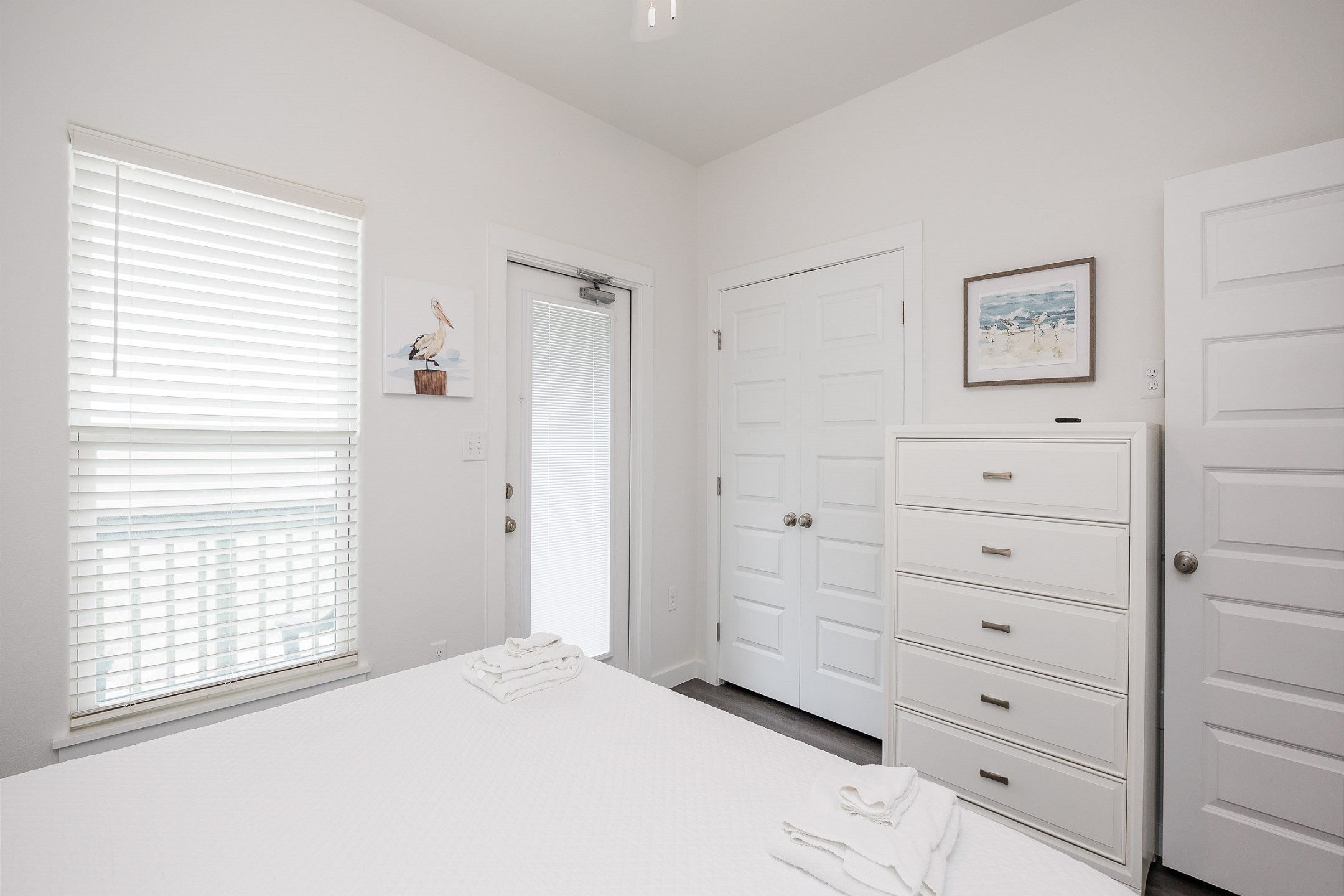 Guest bedroom on the second floor with king size bed, access to private balcony, and flat screen TV 
