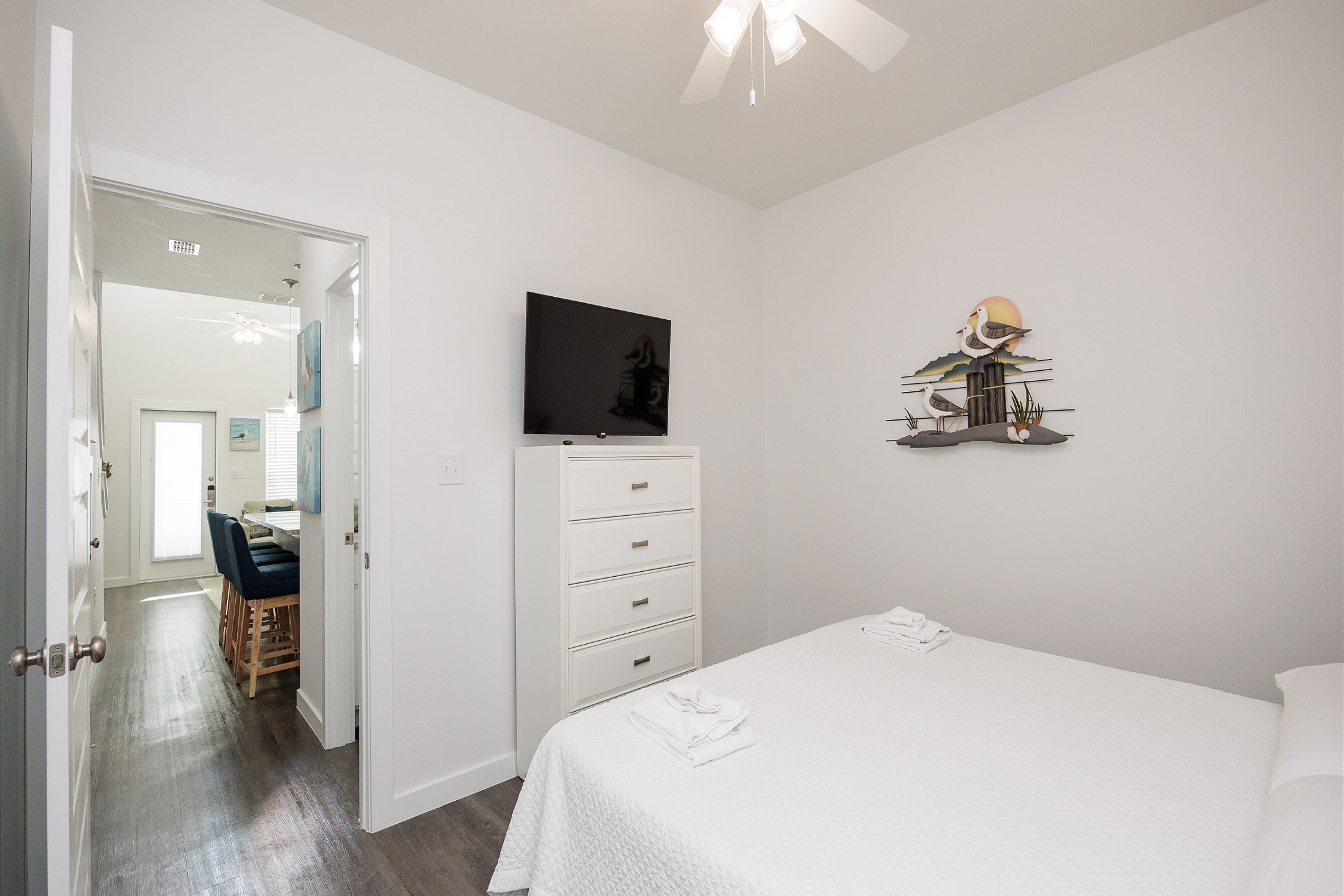Master bedroom on the first floor with king size bed, access to private patio, and flat screen TV 
