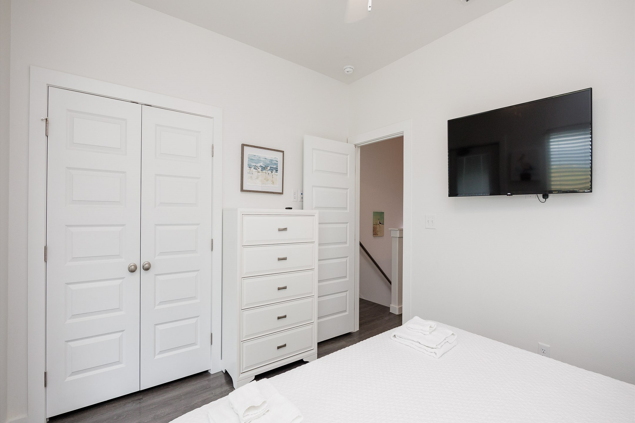 Guest bedroom on the second floor with king size bed, access to private balcony, and flat screen TV 