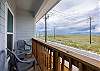 Private balcony off the second bedroom with chairs and Island views 