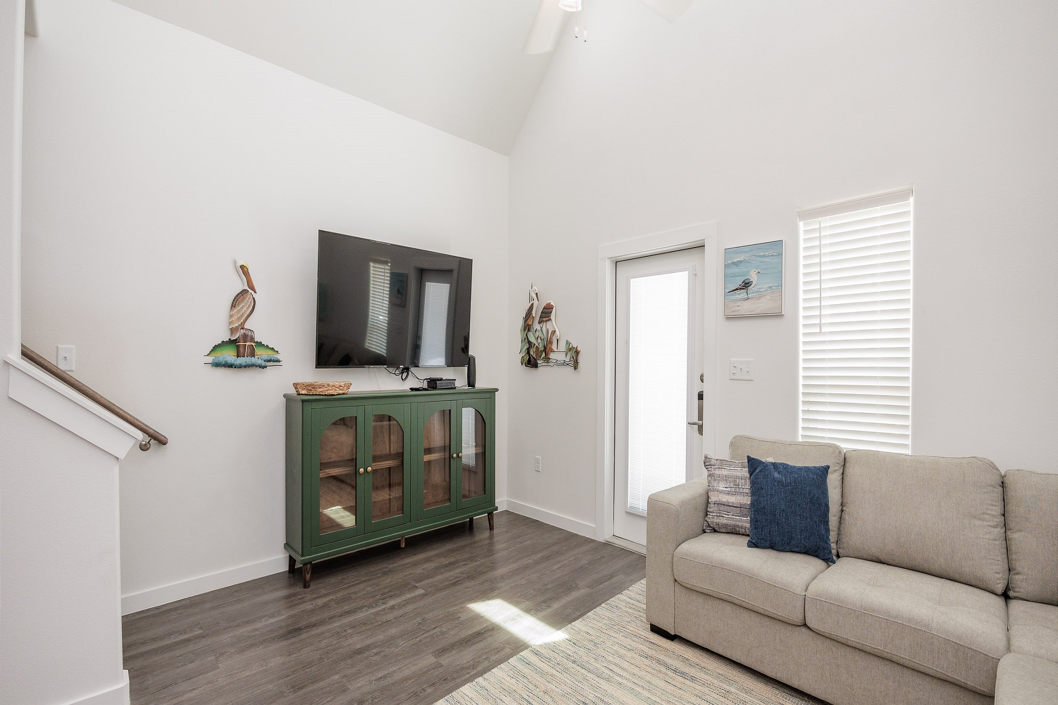 Comfortable living space with high ceilings and bright natural light shining in 