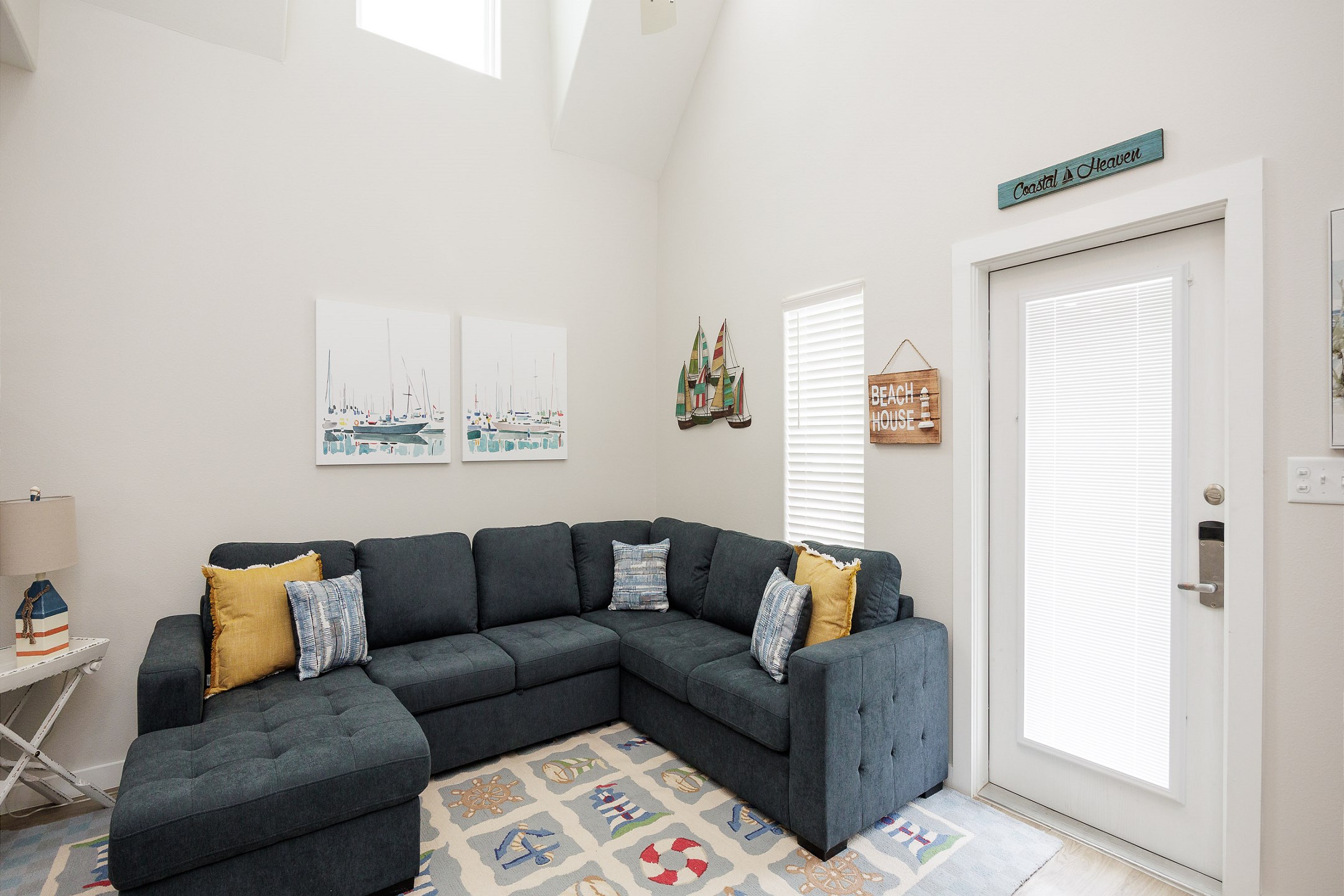 Newly updated living space with cozy sectional that turns into a full size sleeper sofa and coastal decor throughout