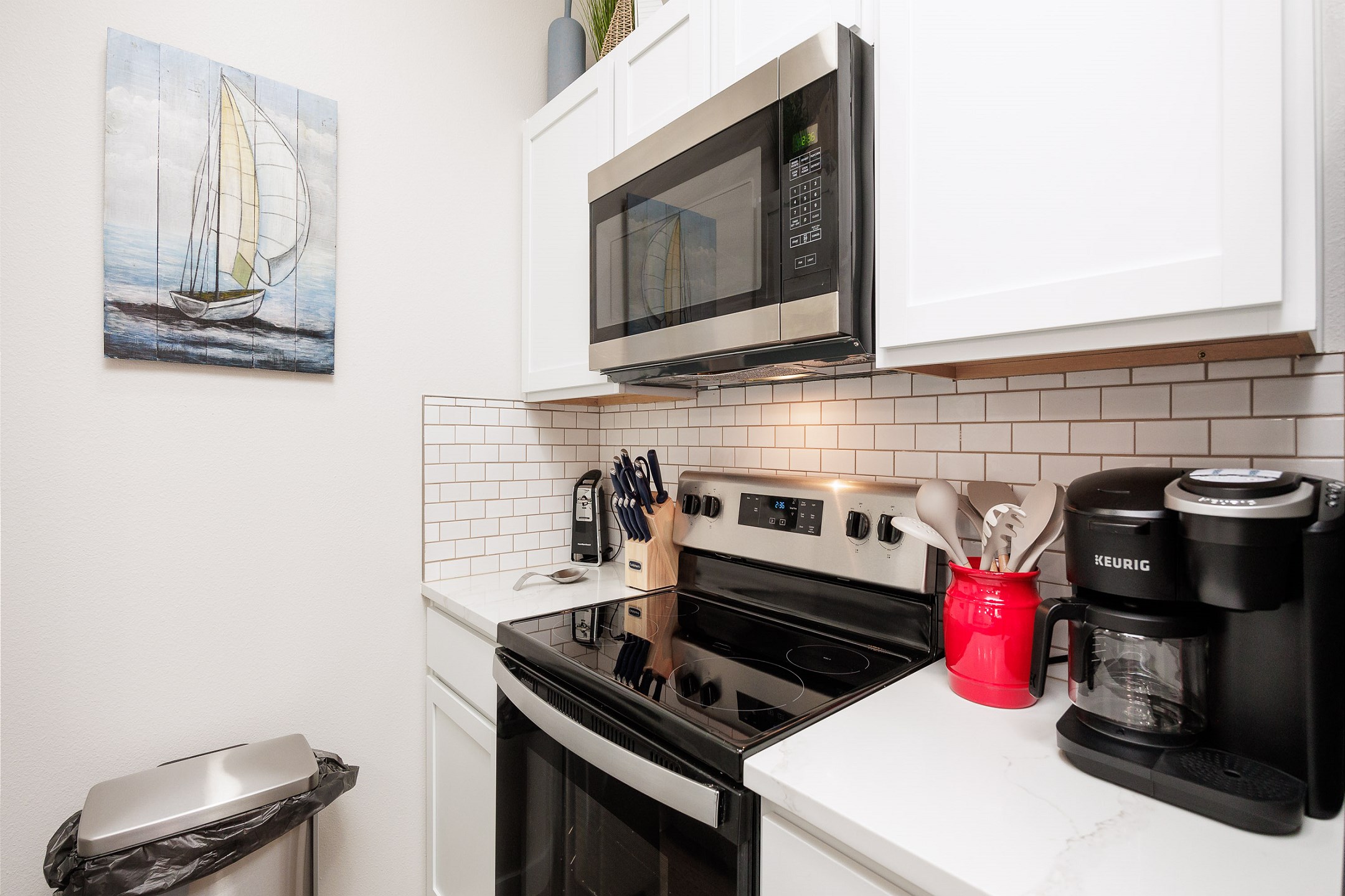 Coffee maker, toaster, cookware, dinnerware, and other kitchen essentials provided