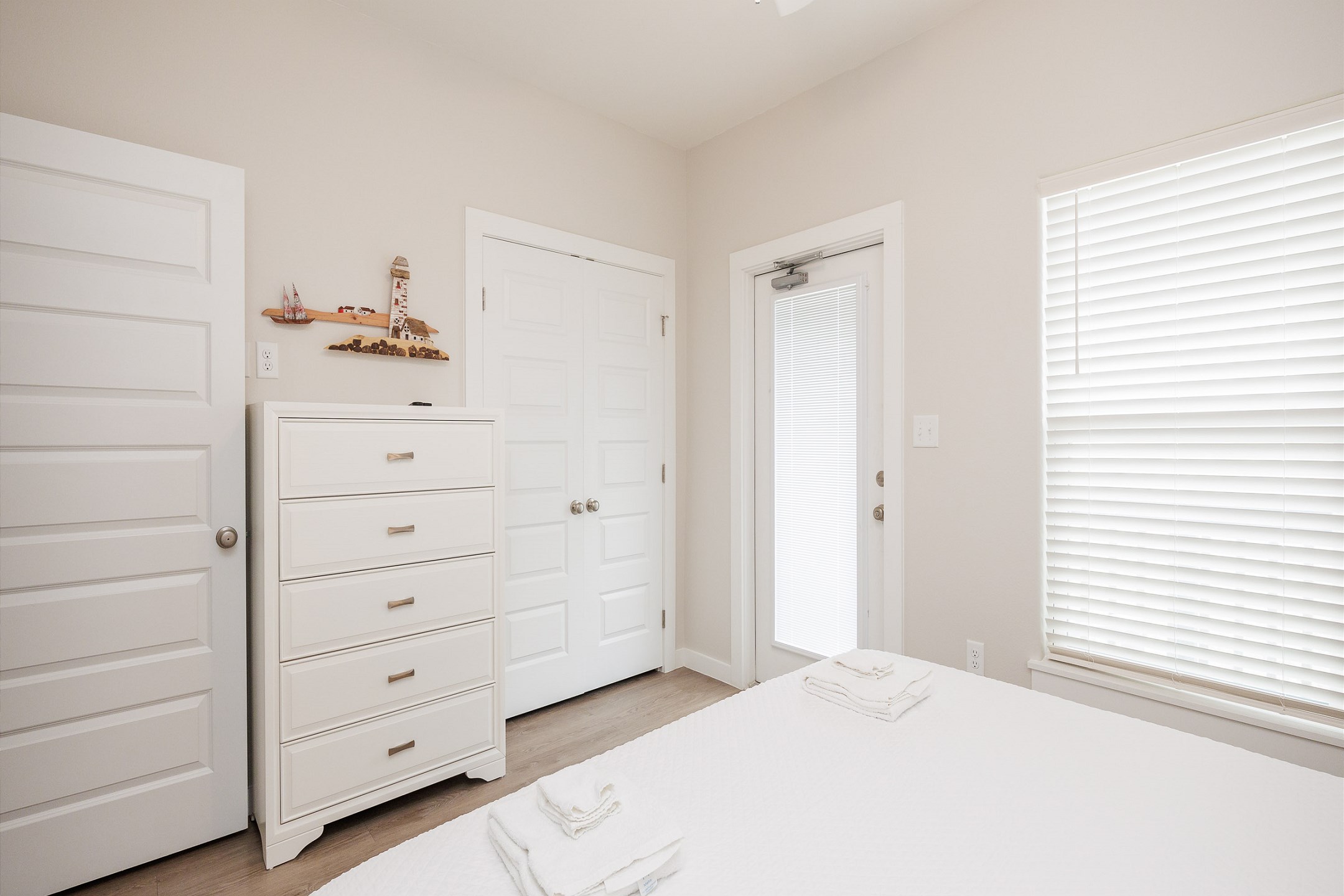 Second bedroom on the second floor with a king size bed, access to the private balcony, and a flat screen TV 