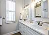 Guest bathroom on the third floor with double sinks, tub and shower 