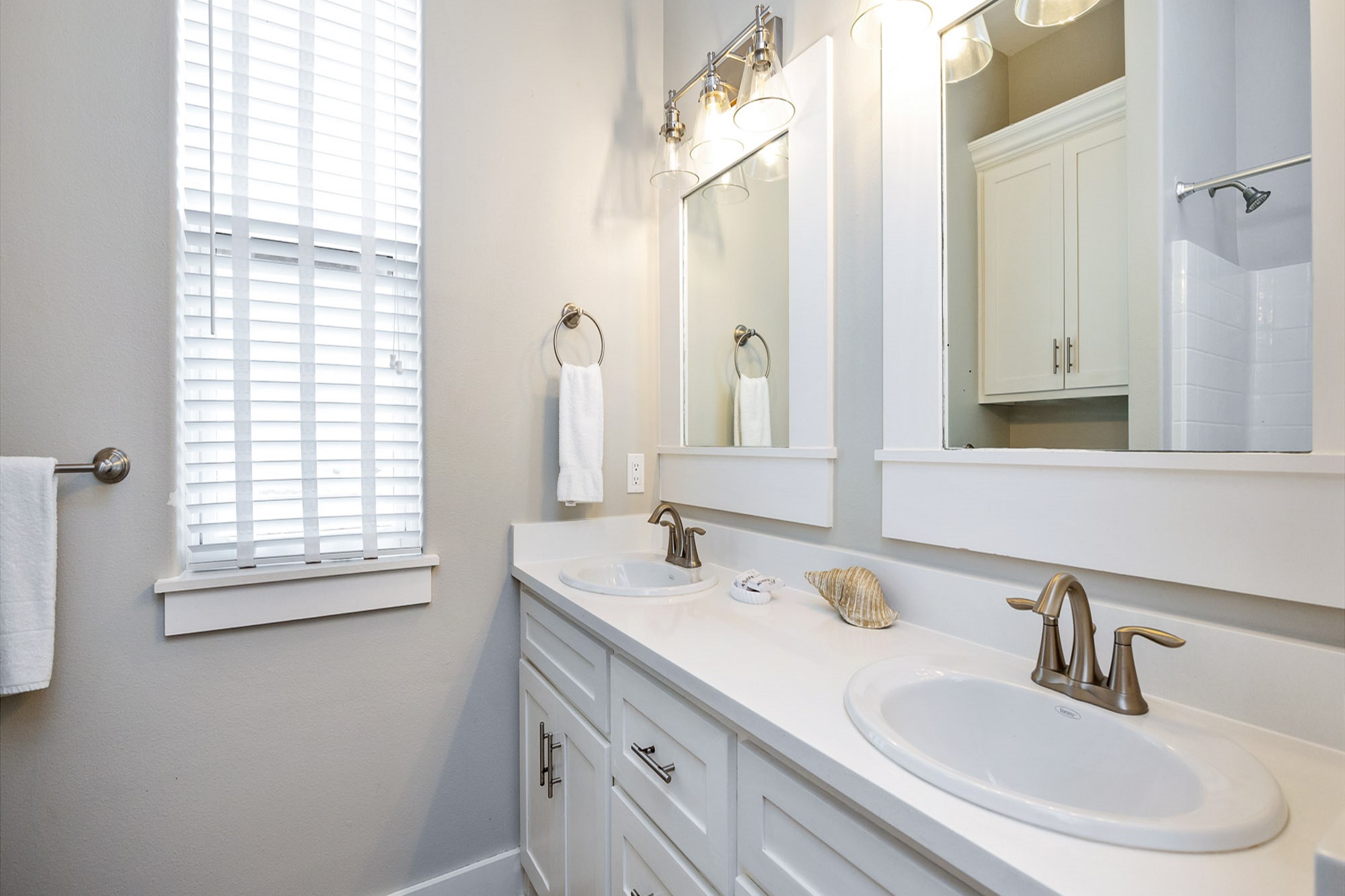 Third-floor guest bathroom with double sinks and a tub-shower combo