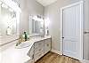 Master bathroom on the third floor with double sinks, tub and shower 