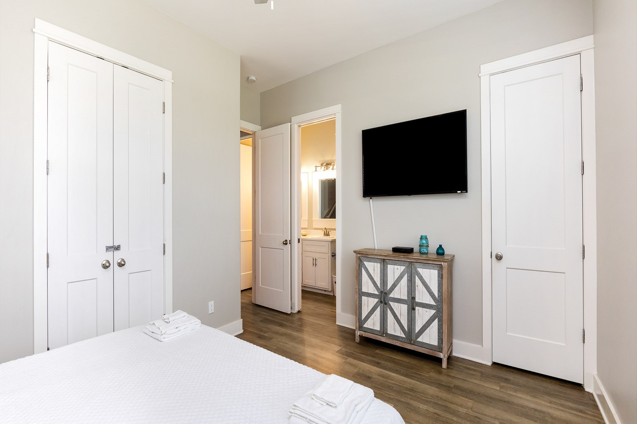 Second bedroom on the second floor with a king size bed, attached bathroom and flat screen TV