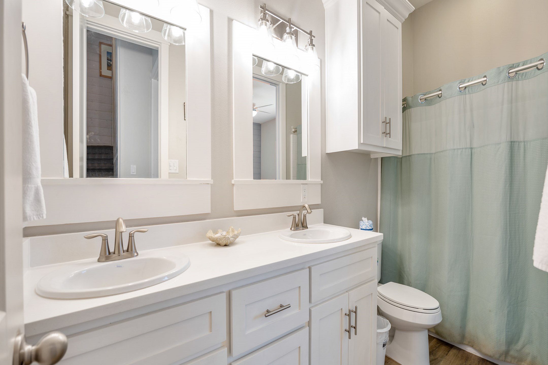 Stylish second-floor guest bathroom featuring a double sink and a walk-in shower - attached to the second bedroom and hallway