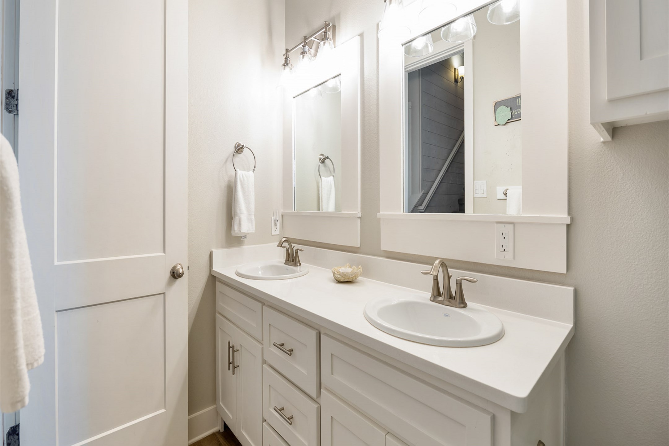 Stylish second-floor guest bathroom featuring a double sink and a walk-in shower - attached to the second bedroom and hallway