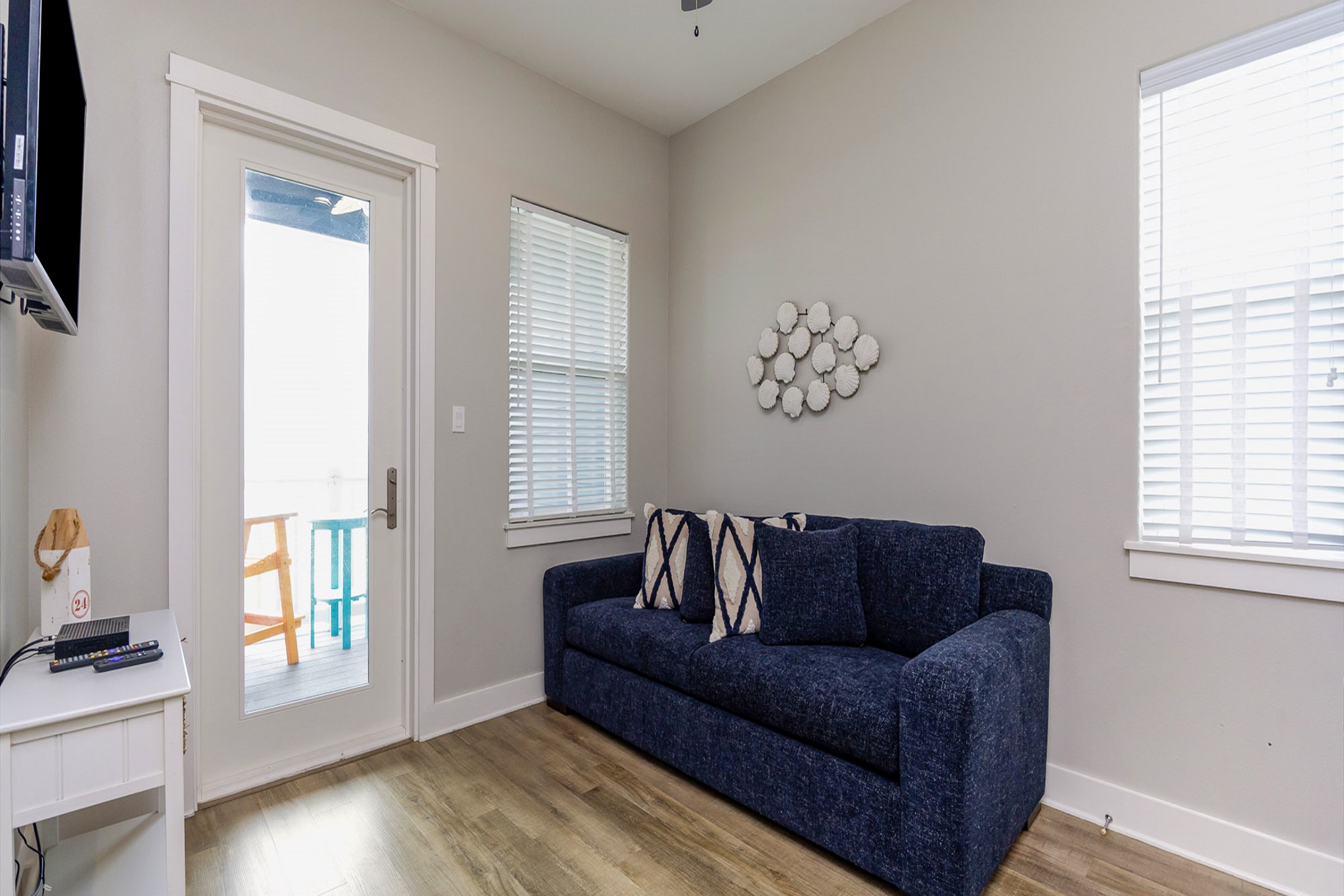 Second living area located on the third floor with balcony access and TV