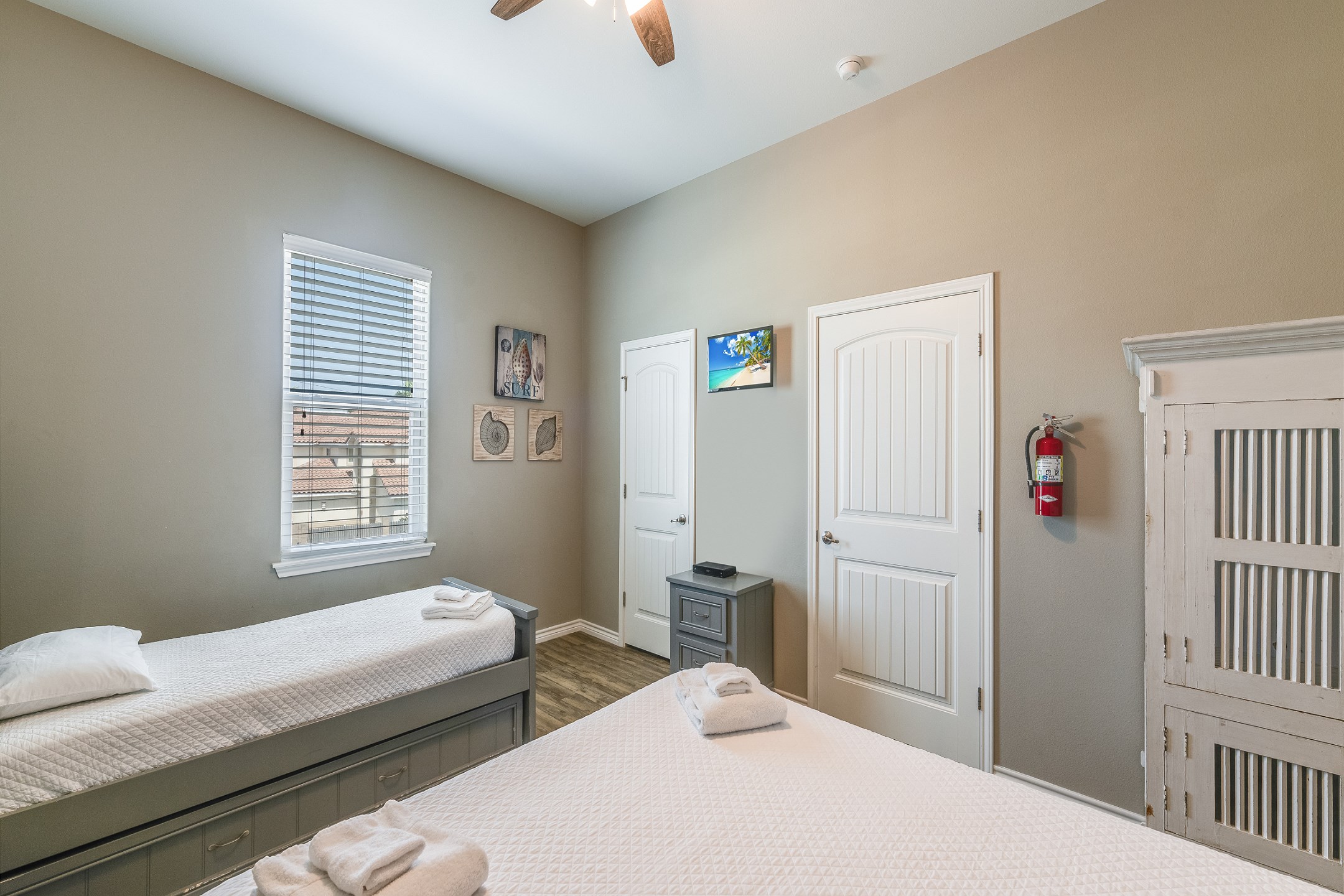 Second bedroom on the second floor with queen size bed, twin size bed and twin trundle, along with flat screen TV and private bathroom