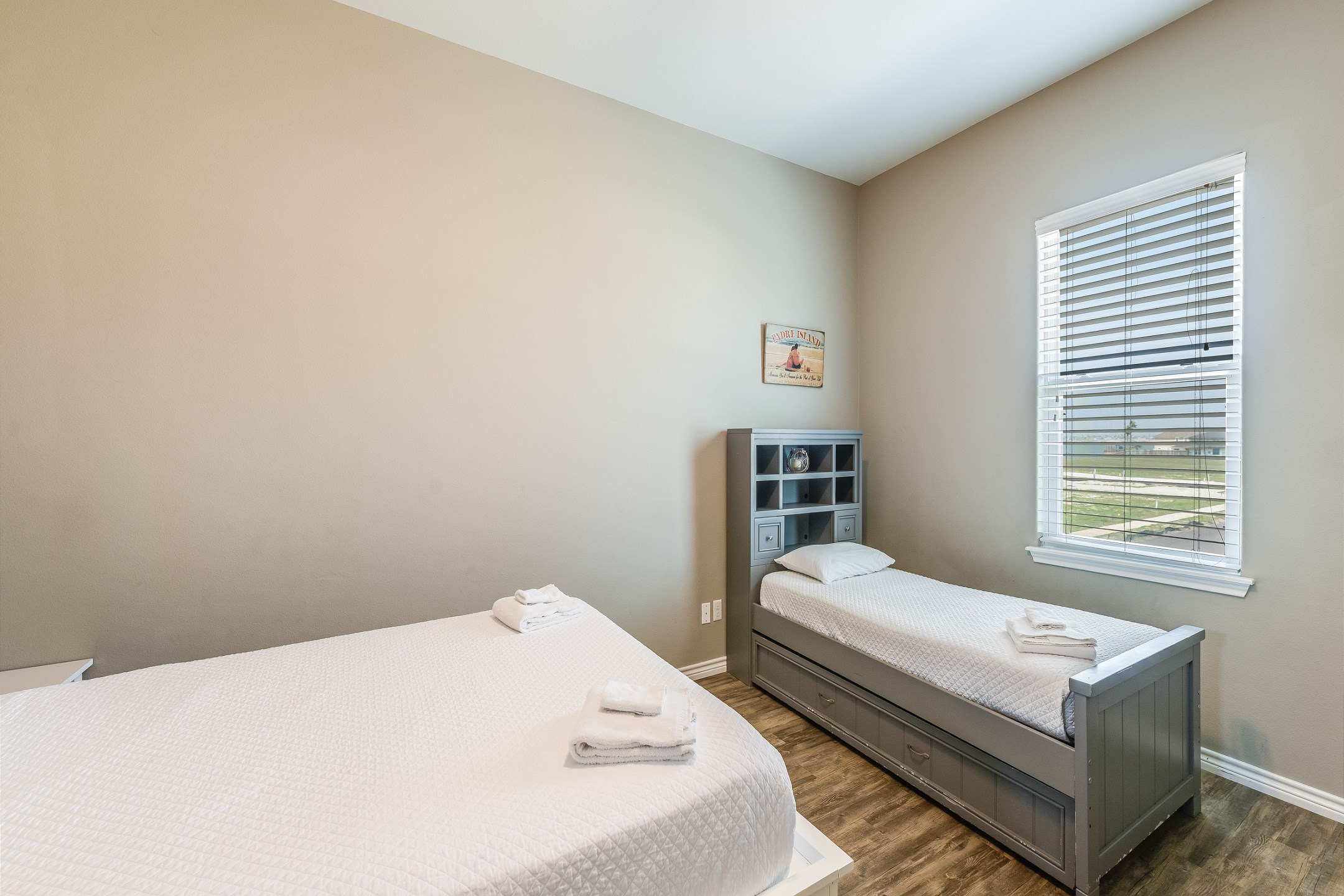 Second bedroom on the second floor with queen size bed, twin size bed and twin trundle, along with flat screen TV and private bathroom