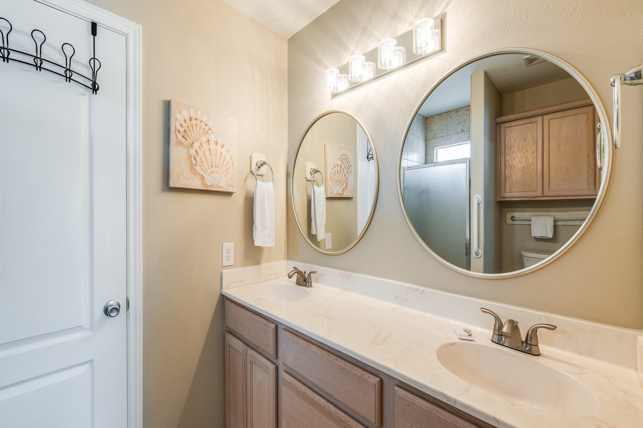 Rinse off the beach day in style in this master bath with double vanities and a walk in shower.