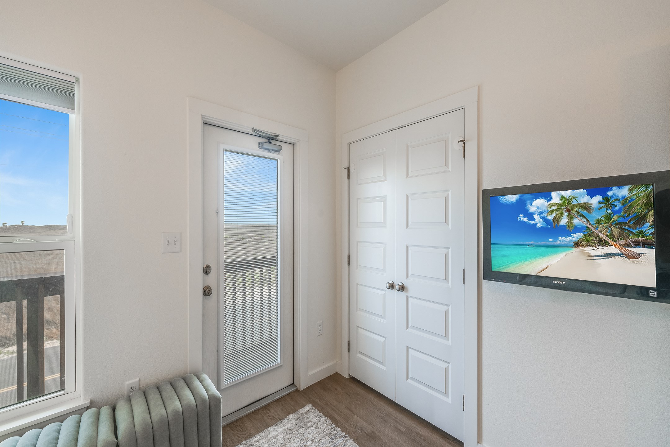 Second bedroom on the second floor with twin-over-full size bunk bed, access to the private balcony, and a flat screen TV 
