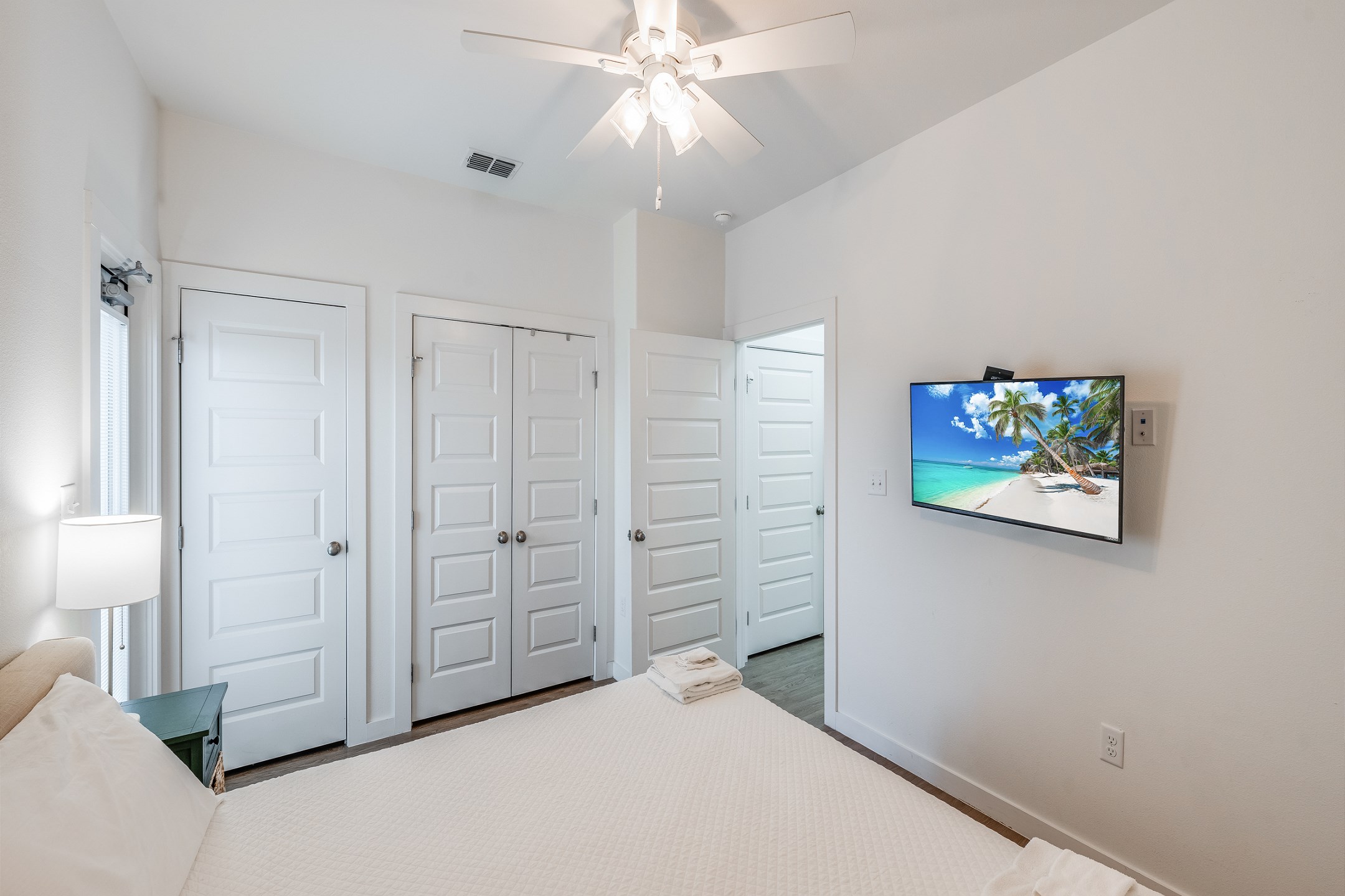 Master bedroom on the first floor with king size bed, access to the private patio, and a flat screen TV 