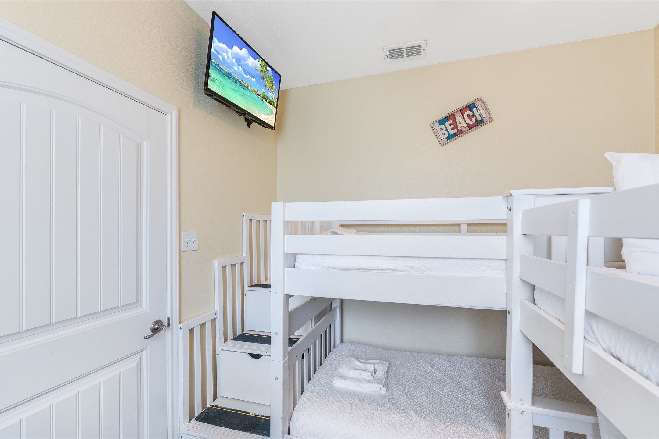 Fifth bedroom on the second floor with two twin-over-twin size bunk beds and flat screen TV