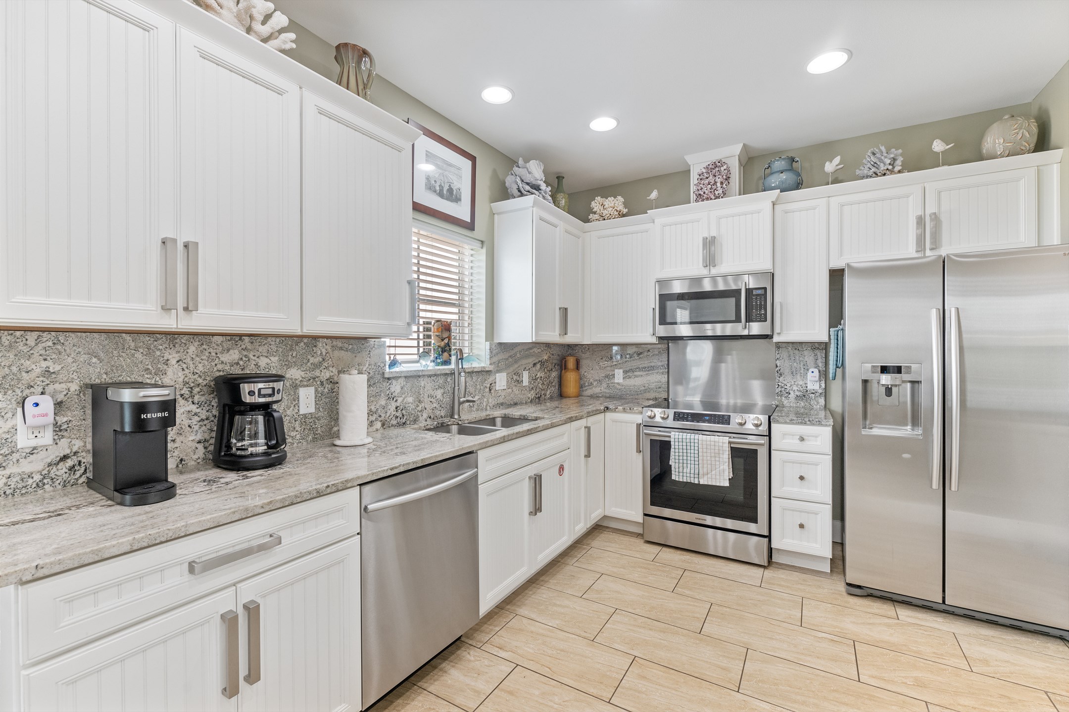 A sleek, modern kitchen with granite countertops, a Keurig or coffeemaker for your morning coffee, and all the tools you need to whip up a vacation meal