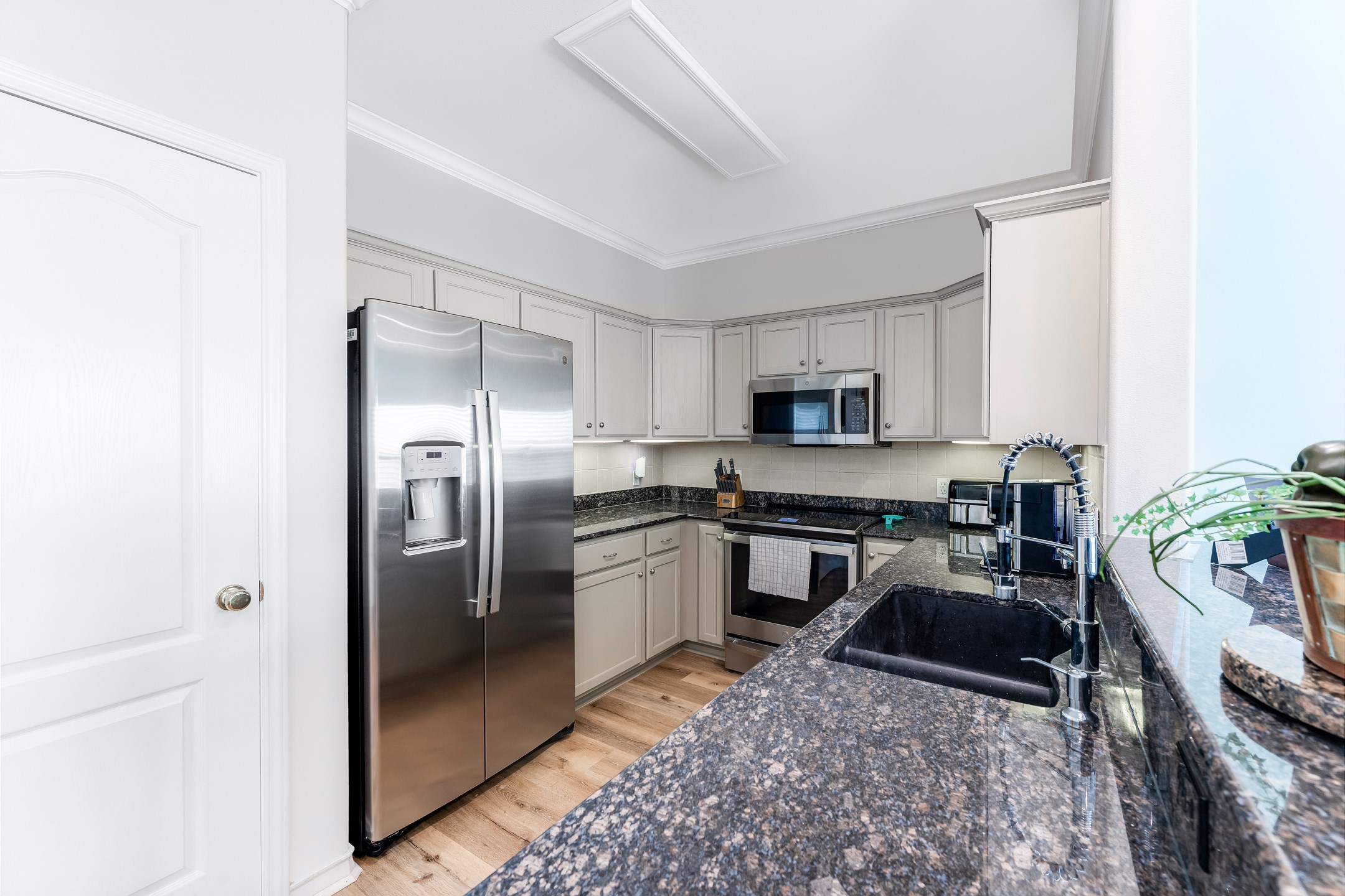 Kitchen includes full-size appliances, cookware, and tableware